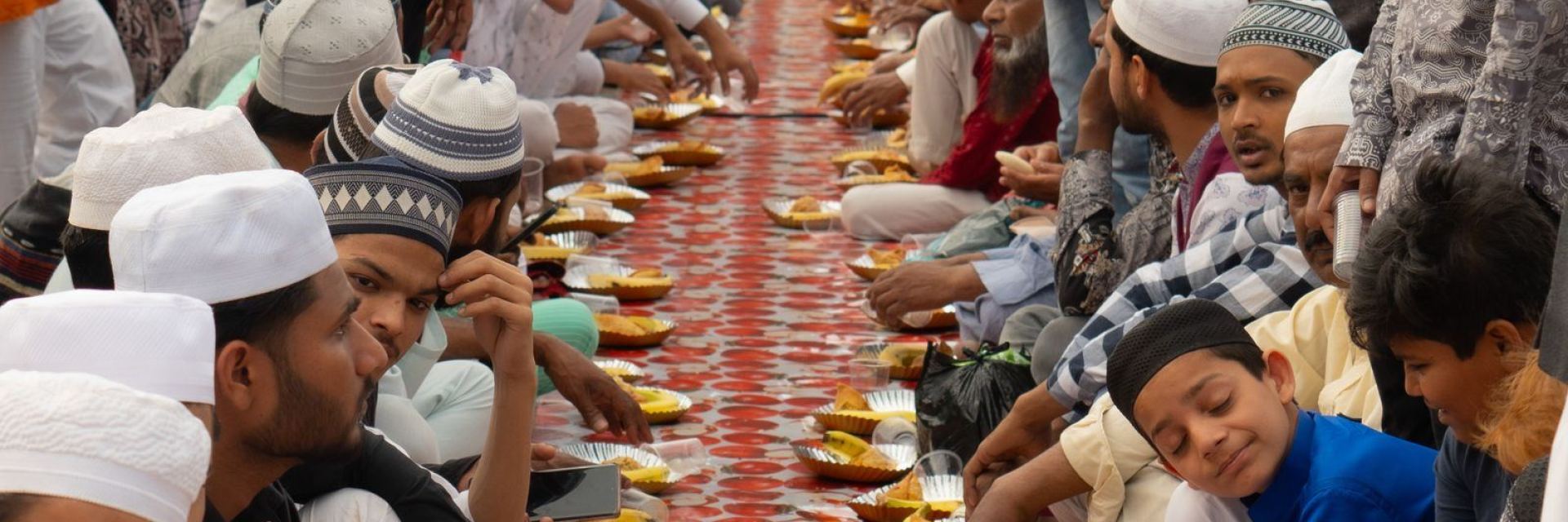 A community iftar meal shared at a long table