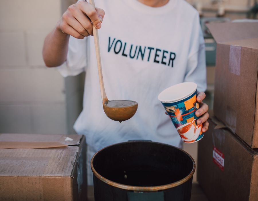 A volunteer serving warm food to those in need