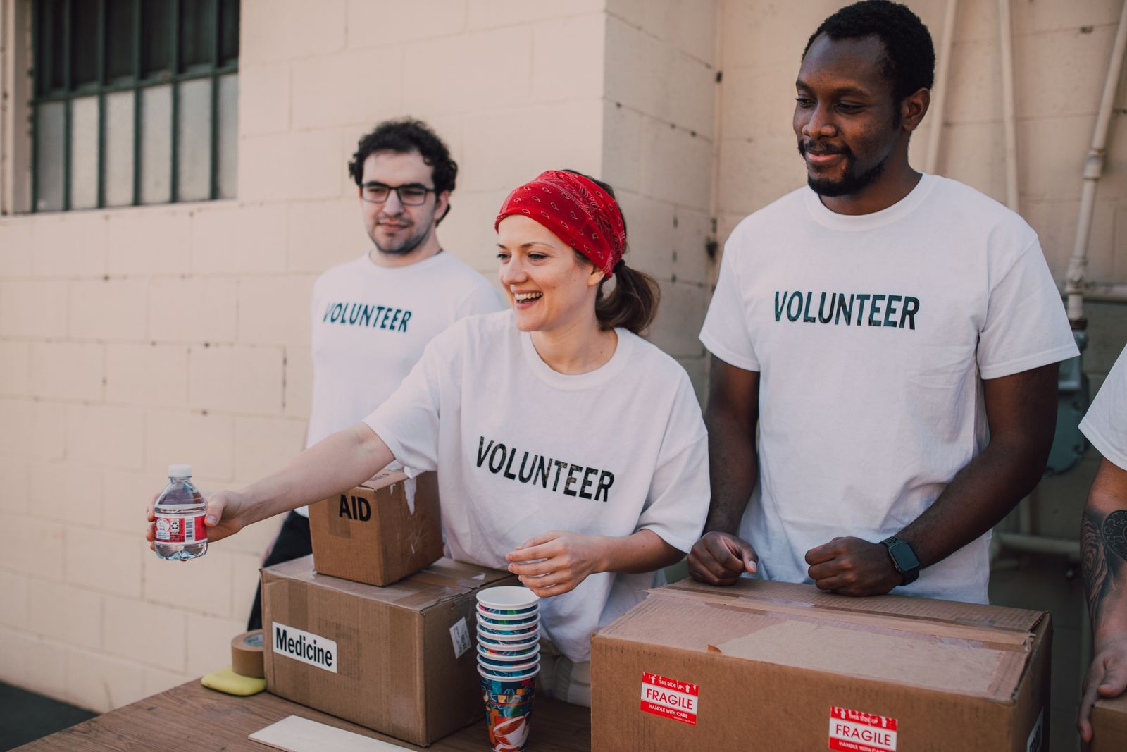 Volunteers packing aid and medicine boxes